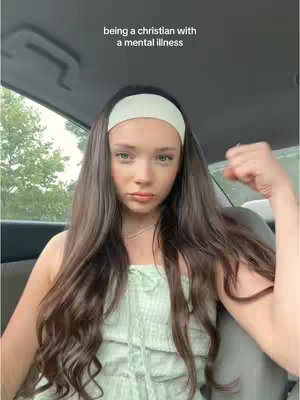 A young woman with long brown hair, wearing a white headband and a light green top, is seated inside a vehicle. The text overlay presents a thought-provoking message, while the woman gazes at the camera with slight eye makeup and neutral expression.