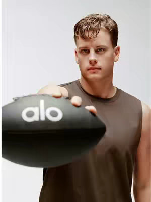 The cover image features Joe Burrow holding a football with the "alo" logo on it. He is wearing a brown tank top. The background is a plain white color.
