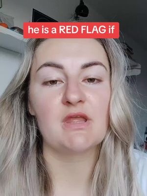 A close-up shot of a woman with blonde hair looking slightly downwards with a neutral expression. She faces the camera directly. A red banner with white text is placed above her head.