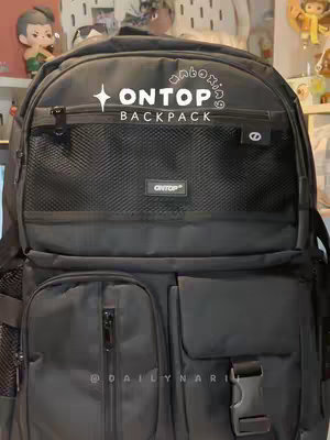 The cover image shows a black ONTOP backpack resting on a surface likely belonging to a desk or shelf. The backpack has a main compartment with a mesh pocket and a front pocket with a zipper and another pocket.  The words 'unboxing' appear above the logo.