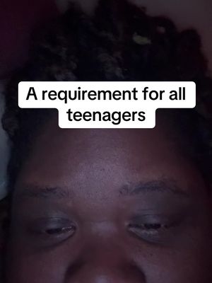 A medium shot shows a person's lower face and eyes, focusing on the eyes, with dark curly hair visible above. A white rectangular text box at the top of the frame reads, "A requirement for all teenagers".