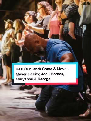 A photograph shows a group of individuals in a dim, interior setting, likely a performance or worship space. The main focus is on a Black man kneeling down with his hands raised, appearing to be in a moment of worship or prayer. Behind him, a diverse group of people, both men and women, are seen with their hands raised as well. Overlaid on the foreground is a colorful rectangular text box containing the song's title and artist information.
