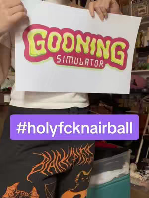 A person holding a white sheet of paper with the words "GOONING SIMULATOR" in large, colorful letters on it. Below, a purple rectangular banner has a text.