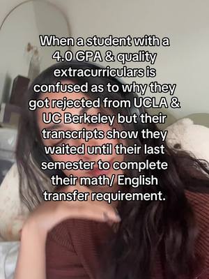 A selfie-style shot featuring a person, with text overlayed that describes a scenario about college admissions. The person has long, dark hair and is looking towards the camera with a neutral expression. The background is softly blurred, suggesting an indoor setting. A large, round mirror is visible in the left side of the frame.