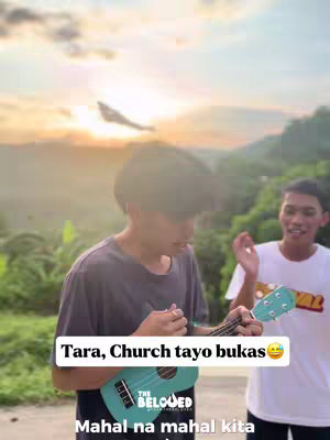 Two young men are featured outdoors, one strumming a ukulele with a turquoise body, the other with his arm raised to the side. The setting appears to be a sunset, with golden light illuminating a green landscape behind them. Text overlaid on the image includes an invitation to church, with the branding of "The Beloved" visible on the ukulele and a text overlay.