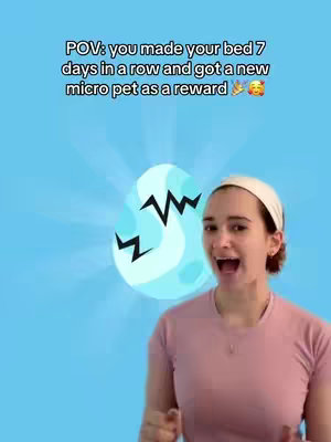 A woman is in the frame with a blue background. In the background, there's an animated egg with black zig-zag on it. The woman is smiling and wearing a pink t-shirt and a white headband