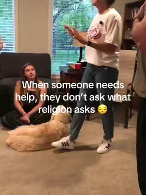 The image captures a casual indoor scene with two women and a dog. A woman in a white t-shirt and jeans stands, gesturing with her hands. Another woman sits on the floor, observing. A golden retriever lies nearby. Text overlays are present, with the focus on a message related to asking the right questions.