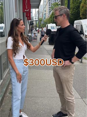 A woman with long brown hair and a white top interviews a man in a black shirt on a city street. The hook text is overlaid with a price of $300USD.