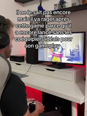 A man is seated at a desk, facing a computer screen that displays a video game. The man wears headphones and holds a game controller. Text overlays the image, commenting on the impending frustration from the game.