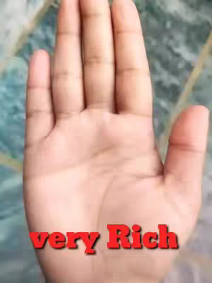 The image shows a person's hand, palm-up, with the text 'very Rich' overlaid in a red, stylized font. The background appears to be a surface with a mottled, slightly iridescent pattern of greens and blues.