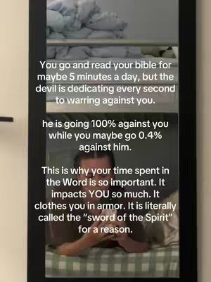 The image appears to be a selfie taken in a bedroom with a mirror in the background. The background includes a shelf with folded clothes. In the foreground is the person with text overlayed. The text appears to be a quote about the Bible and the devil.