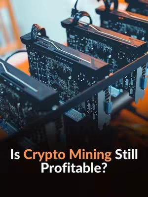 The image shows a close-up of a crypto mining rig, with multiple graphics cards aligned in a row. The cards have exposed circuit boards and fans, suggesting intense computational activity. The background is a gradient of orange and black. Overlayed on the image is the text 'Is Crypto Mining Still Profitable?'