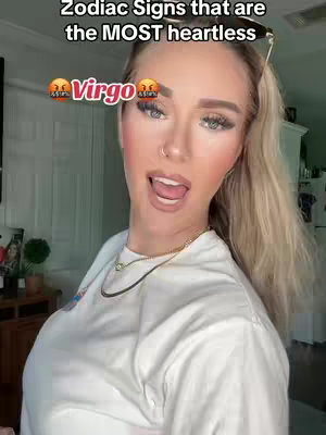 A selfie-style cover image featuring a woman speaking towards the camera with the text overlayed at the top and a zodiac sign below. The woman is blonde, wearing makeup, and has sunglasses on top of her head. Her expression is animated; she's sticking out her tongue. She's wearing a white shirt and a gold necklace