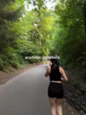 A woman running on a path through a green, blurred forest. Text overlayed on the image reads 'academic comeback' in white font.
