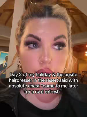 A close-up shot features a woman with blonde hair in a bun and a black top. She has heavy eye makeup and is looking off to the side. Text overlay at the bottom in white reads "Day 2 of..."