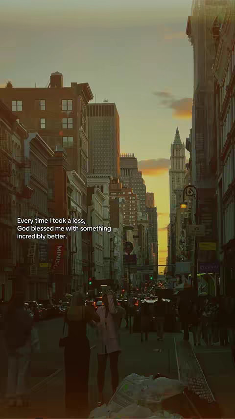 A long shot of a city street with tall buildings on either side. The sun is setting, casting a warm glow over the scene. In the foreground, there are silhouetted figures of people. The text overlay is placed in the center-left of the image.