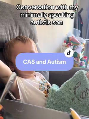 A young boy sits on a gray couch, part of his body obscured by a light green blanket. The text overlay reads "Conversation with my minimally speaking autistic son." A colored banner that says “CAS and Autism”.