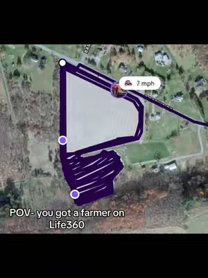 A map-like graphic, likely from Life360, showing a purple path traced over a green and brown landscape. A small icon indicates a car moving along the path; a text overlay says the speed of the car is 7mph, and the text 'POV- you got a farmer on Life360' is at the bottom, against a black background, with a blurred edge.