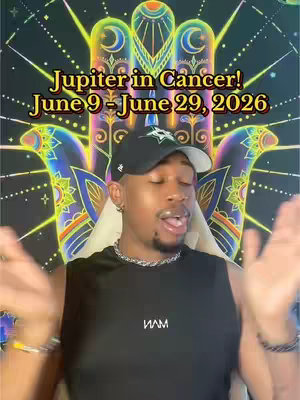 A man with a black cap and sleeveless shirt is in front of a tapestry. Above the man is text that states 'Jupiter in Cancer! June 9 - June 29, 2026'. The center tapestry design is a large hand with colorful and ornate accents. The creator has his hands up with open palms.