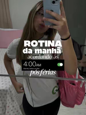 A person is taking a selfie in a room with a bed and part of a pink bag. The person is holding a phone and the screen has text overlays. The overall composition includes text overlays over the original image.