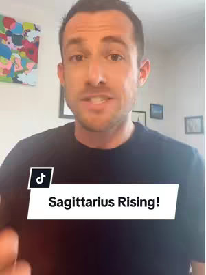 A man is centered in the image, facing the camera and speaking. The background is a room with art and framed pictures. A text overlay that says 'Sagittarius Rising!' is imposed at the bottom.