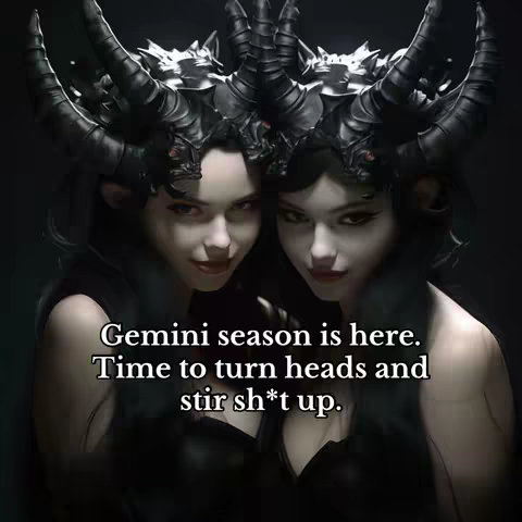 The cover image features two women, each with dark hair and elaborate, dark-colored headwear. They are positioned closely together, with their faces turned slightly towards the viewer, creating a sense of intimacy. The backdrop is a dark, blurry gradient, which highlights the figures in the foreground. Text overlayed in white at the bottom reads: "Gemini season is here. Time to turn heads and stir sh*t up."