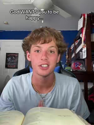 A young man with light brown hair is sitting in a room, speaking towards the camera. The image is well-lit with the man as the central focus. There is text overlaid at the top of the image.