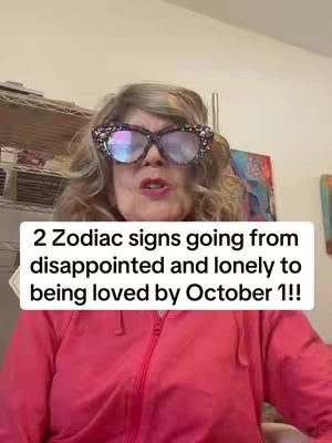 A woman with blonde curly hair wears large, sparkly glasses and a pink zip-up jacket. Text is overlaid on the image.
