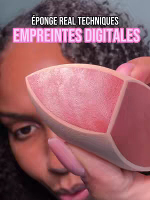 A close-up shot features a person holding a pink makeup sponge. The sponge has three distinct sections, including one aiming to imitate fingerprints. Text overlays at the top. The image is set in a neutral background where a person's face and hand are seen.