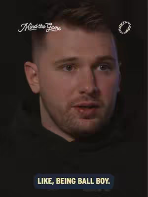 A close-up shot features a man with short hair and a slight beard. The background is dark. At the bottom, a text overlay reads, "LIKE, BEING BALL BOY." Logos circle the man's head.