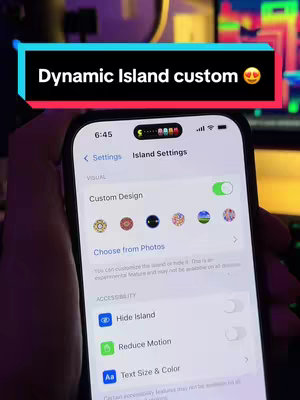 The cover image displays a close-up view of an iPhone screen, showcasing the 'Island Settings'. A highlighted text overlay above the screen reads "Dynamic Island custom". The screen displays a custom design, with options to choose different designs, the time is in the top left corner and other settings below.