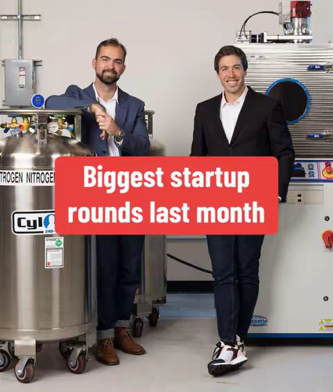 Two men in suits stand in front of large industrial tanks and machinery. A red banner across their mid-section reads "Biggest startup rounds last month."