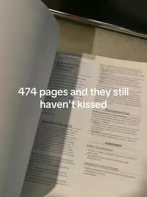 The image shows a textbook open to pages with medical terminology and notes. The text overlay reads '474 pages and they still haven’t kissed'. The background is a desk or table.