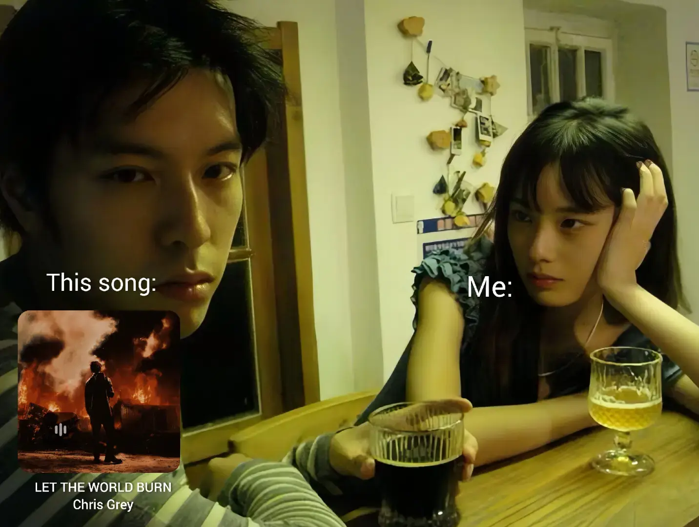 A meme-style image showing two people in a room. On the left, a person looks directly at the camera with a serious expression, overlaid with text saying 'This song:' and a small album cover. On the right, another person rests their head on their hand, looking thoughtful, with the text 'Me:' overlaid on them. Both have drinks in front of them, and the background shows kitchen decor.