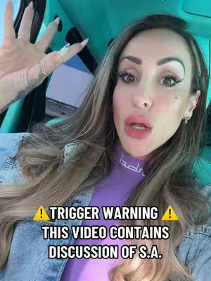 A selfie-style shot featuring a woman in a car, with her hand raised and text overlay across the bottom. The woman has long, wavy hair and is wearing a purple top. The lighting appears to be natural, with a soft focus on her face. The background shows the interior of a car with a green dashboard.