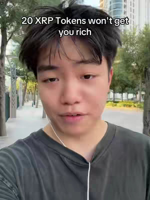 A selfie-style video shows a young man wearing dark-colored clothing, framed from the chest up, and standing outdoors with a blurred background of trees and buildings. Text is overlaid at the top of the frame.