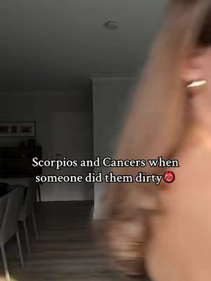 The cover image shows a blurred interior scene, likely a home, with a person's arm and shoulder visible on the right side. Text overlayed at the bottom reads, "Scorpios and Cancers when someone did them dirty" with a red heart emoji.