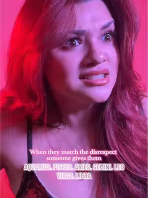 A close-up of a woman's face, with a shocked expression. The background is a vibrant reddish-pink, which casts the same color across her fair skin and hair. She has large eyes, visible in the close-up, and her mouth is slightly agape, showing her teeth. Text overlaid at the bottom explains the topic.