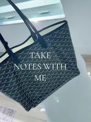 The cover image features a black and gray tote bag, placed diagonally across the frame. The bag has a repeating pattern and black handles. Text overlayed in white says, "TAKE NOTES WITH ME". The background is a light-colored surface, possibly a table or counter.
