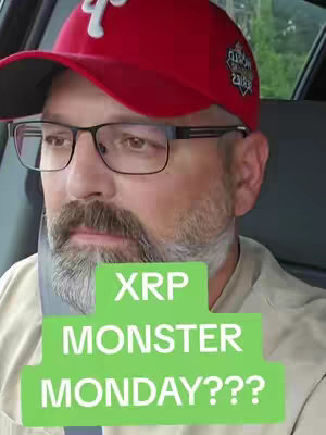 A man wearing glasses and a baseball cap is seen from the shoulders up, sitting in a car. The cap is red with a white 'P'.  A green rectangle overlay contains the text 'XRP MONSTER MONDAY???'.