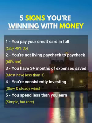 The image is a vertical graphic featuring a title and a list of financial metrics against a backdrop of a castle and a twilight sky. The title "5 SIGNS YOU'RE WINNING WITH MONEY" appears at the top in a bold, yellow font, with the word "WINNING" in a larger, emphasized style. Below the title, there's a numbered list of five signs, each detailing a financial habit or achievement. The list is white font with additional information in gray font. The bottom portion of the image shows the castle, the sea and evening skyline