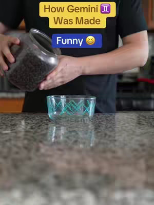 A person is pouring dark, possibly chocolate, chips from a clear jar into a patterned glass bowl on a speckled countertop. Above, a yellow banner reads 'How Gemini Was Made,' with a Gemini symbol, and below, a blue banner says 'Funny' with a laughing emoji.