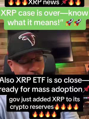 A man wearing a black hat and glasses is centered in the frame, with text overlays above and below him. The text discusses XRP news and predictions. The background shows a blurred interior with what appears to be a computer monitor and wooden paneling.