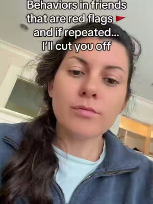 A woman with dark hair in a ponytail looks directly at the camera with a slightly stern expression. Overlaid text at the top reads, "Behaviors in friends that are red flags and if repeated... I'll cut you off."