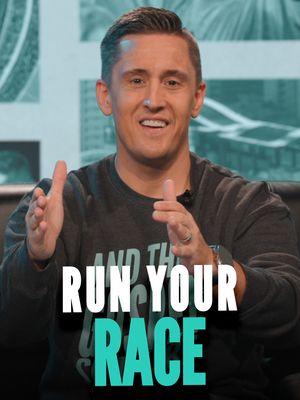 A man with short dark hair and a friendly expression is the focus of the image. He's wearing a dark gray sweatshirt. The phrase "RUN YOUR RACE" is overlaid on the image in large, bold, white capital letters with a teal outline, positioned at the bottom. The background suggests a studio setup with a blurred cityscape design.