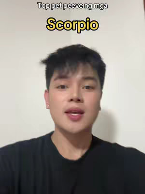 A man with dark hair and a black t-shirt is the central figure, framed in a medium shot against a plain white background. Overlaid on the image is text in a yellow-outlined font. The overall composition is simple, with the focus on the person.