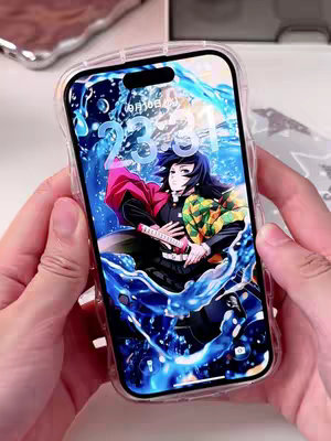 A person holds a phone with a clear case, showcasing a vibrant wallpaper featuring an anime character from "Demon Slayer." The wallpaper displays a dynamic scene with flowing blue water elements, a central anime character with black hair and a patterned haori, holding a sword. The upper center of the phone screen displays the date "9月10日" and the time "23:31". The hands holding the phone are visible against a white background.