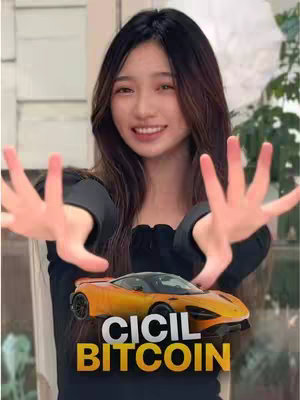 A young woman with long dark hair, wearing a black top, poses with an orange toy car. She is smiling and holding her hands out towards the viewer, framing the car that is superimposed with the text "CICIL BITCOIN". The background is somewhat blurred, suggesting an interior setting. The overall composition is bright and engaging.