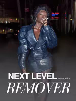 A stylish individual with slicked-back hair and dark makeup poses on a street. They wear a sharp, futuristic, dark blue leather jacket-dress, and hold a lit cigarette between their fingers. Text overlays indicate a beauty product and a brand.