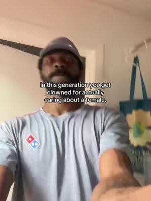 A medium shot featuring a man wearing a gray hat and a gray Domino's t-shirt. He is looking into the camera. Text overlayed at the top.